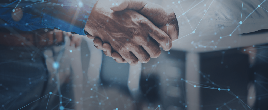 A semi-transport image of two businessmen shaking hands, a modern city skyline in the background.Dots  and lines overlay the scene, symbolising a digital connectivity between them.