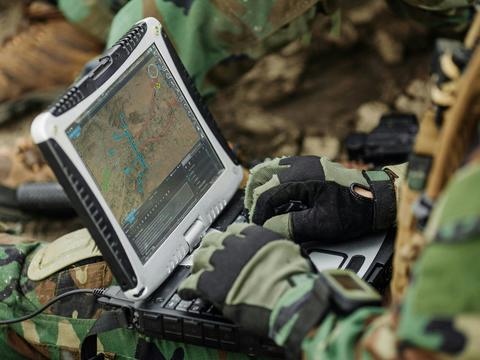 Soldier typing on a computer