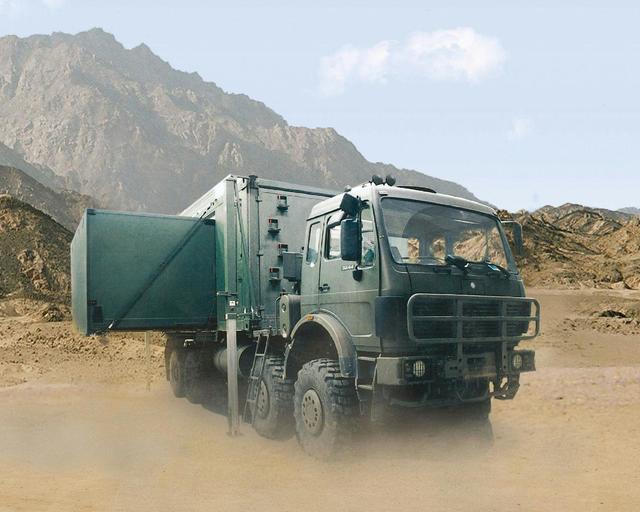 An extended 1:3 container-based mobile command post on a truck within the dessert