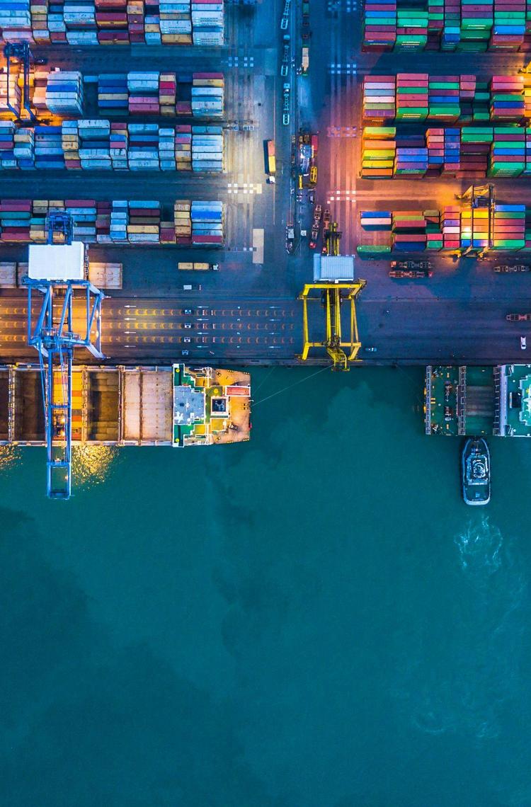 Overhead perspective of a container ship loaded with various cargo containers, showcasing maritime logistics.