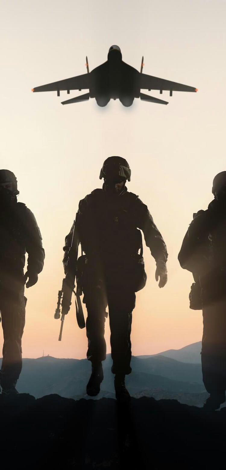 Shadows of five soldiers in a row with fighter jets in the air above them