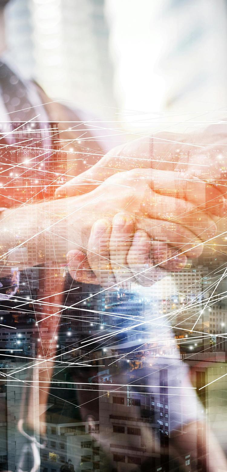 A semi-transport image of two businessmen shaking hands, a modern city skyline in the background.Dots  and lines overlay the scene, symbolising a digital connectivity between them. 
