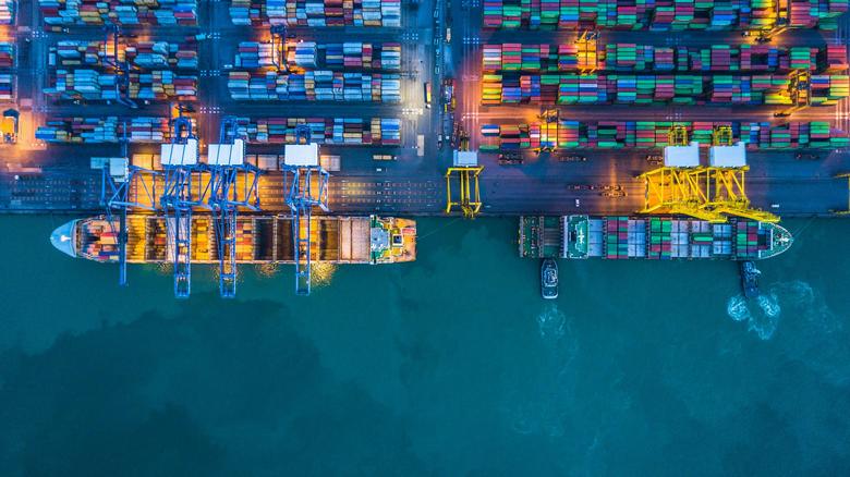 Overhead perspective of a container ship loaded with various cargo containers, showcasing maritime logistics. 